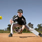 SKLZ yellow reaction training ball in mid-air above baseball player in fielding position on dirt field