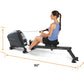 Woman using black LifeSpan RW1000 rowing machine with blue tank top, demonstrating proper form on equipment with dimension me