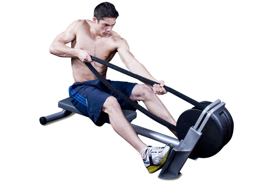 Man using black Ropeflex RX2200 horizontal rope trainer with dual handles, wearing navy shorts and sneakers on white backgrou