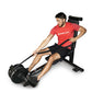 Man wearing red Ropoflex t-shirt using black Ropeflex RX2300 rope trainer machine with adjustable seat on white background