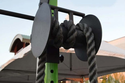 Black rope pull attachment with dual handles mounted on green metal frame with black pulleys