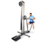 Man in blue shirt using tall black and gray upright rope trainer machine with weighted pulley system on white background