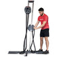 Man in red shirt using gray and black upright rope trainer with dual handles on white background