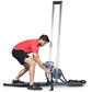 Man in red shirt using Ropeflex RX1500 upright rope trainer with tall metal frame on white background