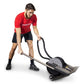 Man wearing red Ropeflex t-shirt and black shorts using compact rope trainer with black handles on white background