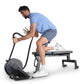 Man using black Ropeflex RX2000 rope trainer while seated on exercise bench, wearing light blue shirt and navy shorts