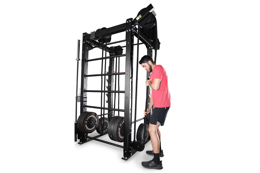 Black steel Smith machine with rope trainer attachment, model man in pink shirt demonstrating use on white background