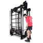 Man in red shirt using black cable machine trainer with weight plates on white background