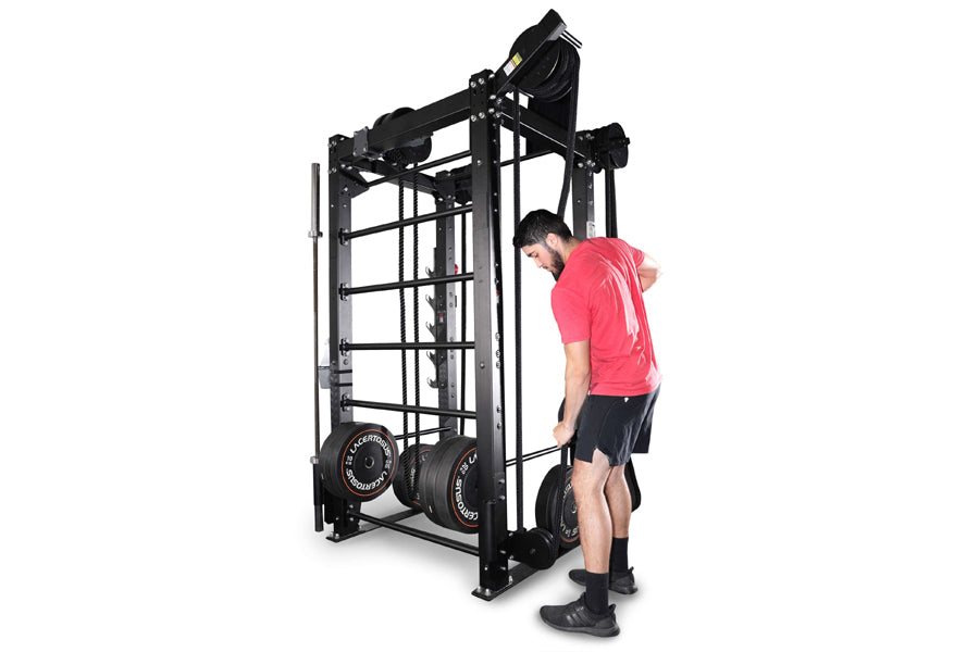 Man in red shirt using black cable machine trainer with weight plates on white background