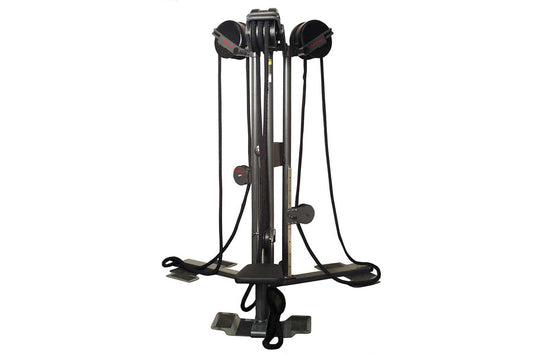 Black vertical rope trainer with dual handles and foot platform on white background