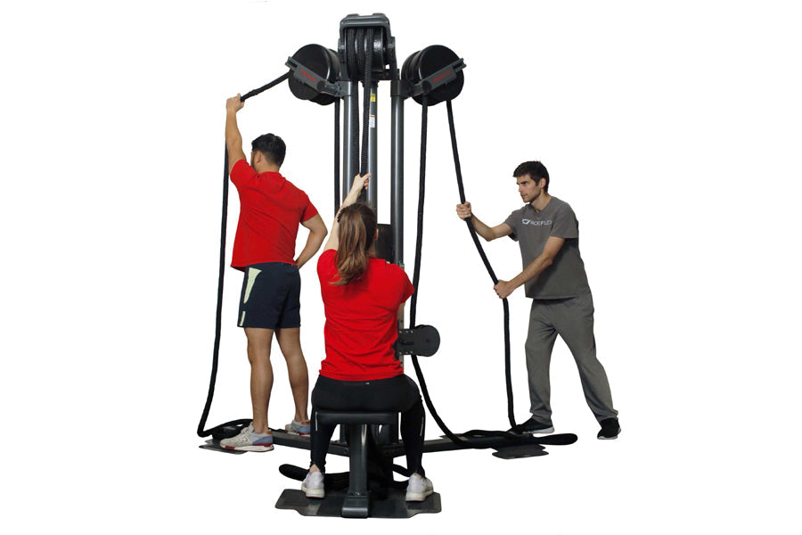 Black and gray multi-station rope training machine with two black rope handles, used by three people in workout attire on whi