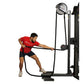Man in red shirt using black Ropeflex rope trainer machine with circular weight indicator and rope attachment on white backgr