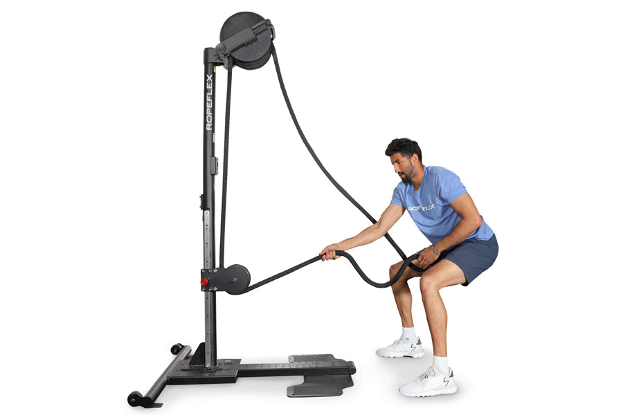 Man using black Ropeflex upright rope trainer with adjustable pulley system on white background