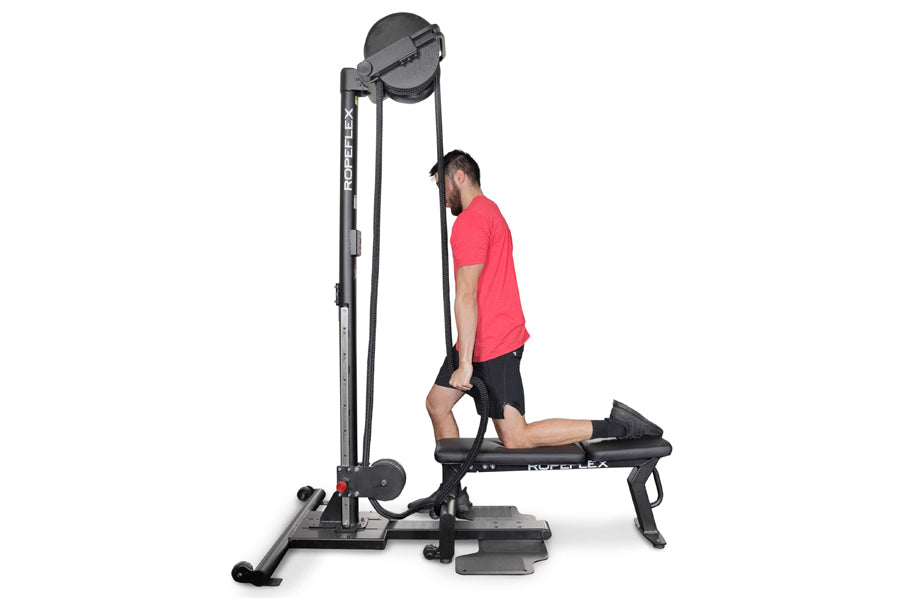Man in red shirt using black Ropeflex rope training machine with adjustable pulley system on white background