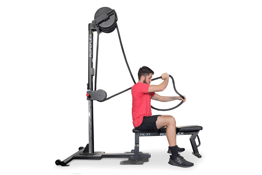 Man in red shirt using black Ropeflex RX2500 upright rope trainer with pulley system on white background