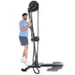 Man in blue t-shirt and navy shorts using black upright rope trainer with overhead pulley system on white background