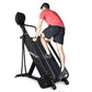 Man in coral t-shirt and black shorts using black Ropeflex RX4400 rope climbing machine on white background