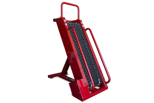 Red metal stair climbing machine with black textured tread surface and dual handles on white background
