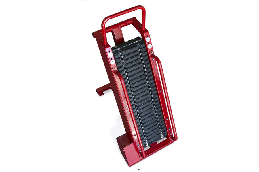 Red metal climbing rope trainer with black textured tread surface and carrying handle, shown on white background