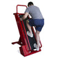Man using red climbing machine with black treamill surface and control panel, worn on white background