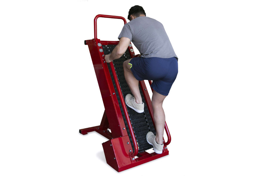 Man using red climbing machine with black treamill surface and control panel, worn on white background