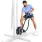 Man using black rope drum attachment on white frame, wearing blue graphic tee and navy shorts
