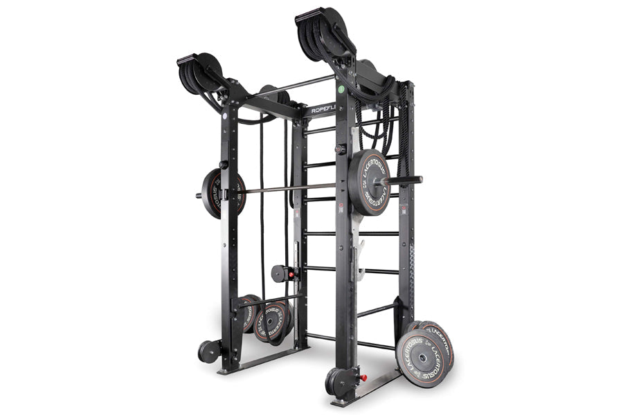 Black multi-functional strength training rack with dual cable systems, weight plates, and adjustable pulleys on white backgro