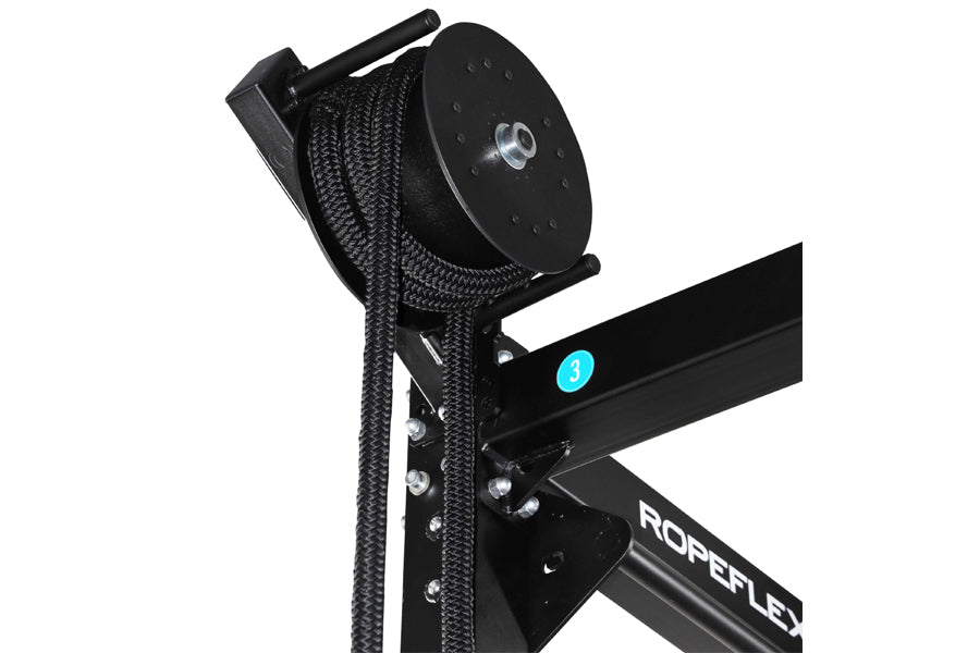 Black rope trainer attachment with braided nylon rope and pulley system, mounted on Ropeflex equipment frame with cyan accent