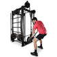 Man in red shirt using black metal cable machine with rope attachments on white background
