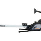 SHI-ROW Air rowing machine with black and gray body, orange accents, and extended silver rail on white background