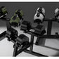 Adjustable dumbbell set with olive green, white, and black weights on black stands, displayed on gray background