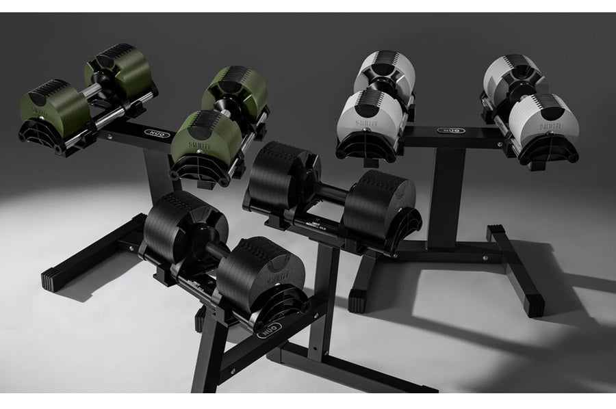 Adjustable dumbbell set with olive green, white, and black weights on black stands, displayed on gray background