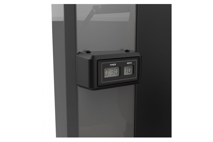 Black digital timer and rep counter display mounted on gray exercise equipment frame