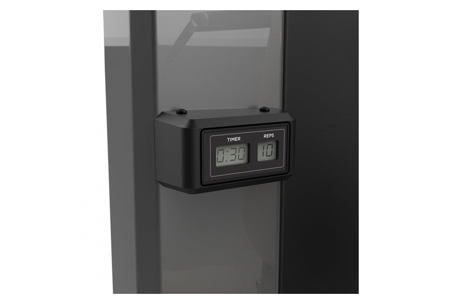 Black digital timer and rep counter display mounted on gray leg press machine frame