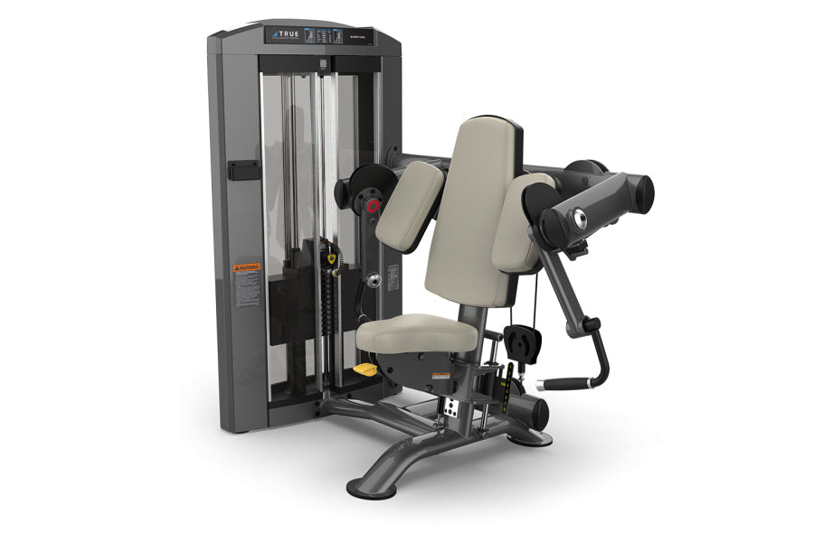 TRUE SPL-0600 seated bicep curl machine with gray frame, beige padded seat and armrests, black handles, on white background