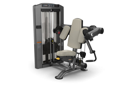 TRUE SPL-0600 seated bicep curl machine with gray frame, beige padded seat and armrests, black handles, on white background