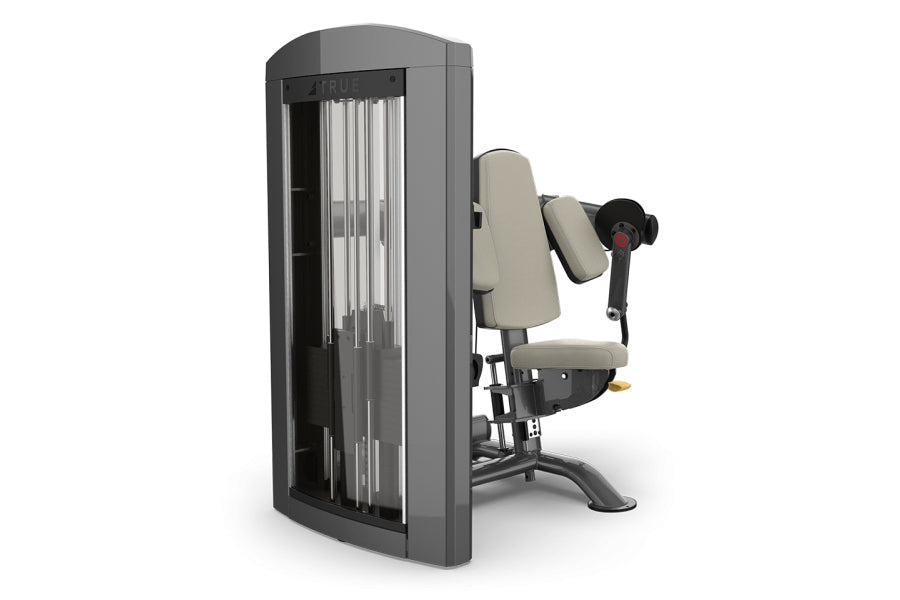 TRUE SPL-0600 seated bicep curl machine with gray frame, beige padded seat and back support, and black handles on white backg