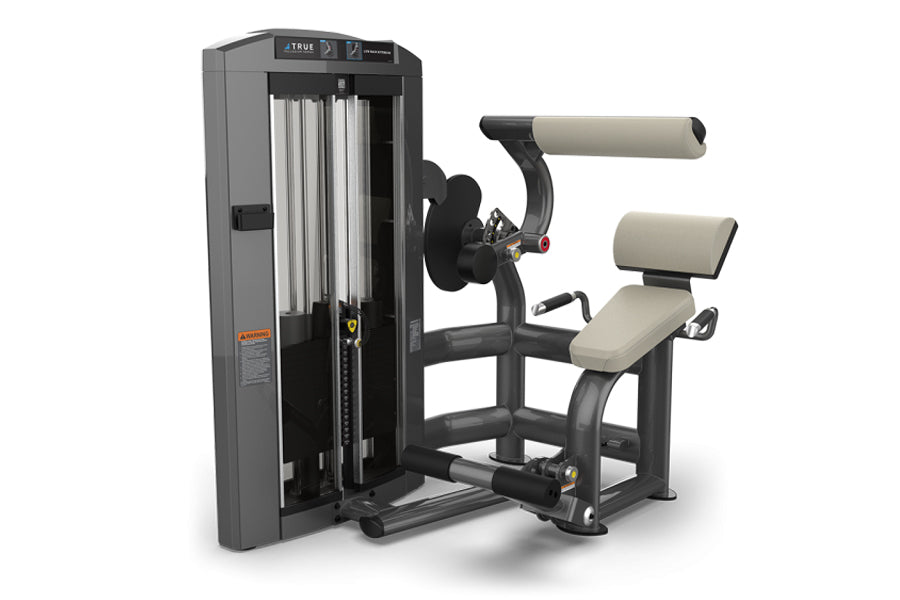 TRUE SPL-1300 low back extension machine with gray frame, cream padded seat and backrest, and black weight stack on white bac