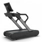 Black and gray TRUE Stryker commercial treadmill with slat belt, digital display, and dual handles on white background