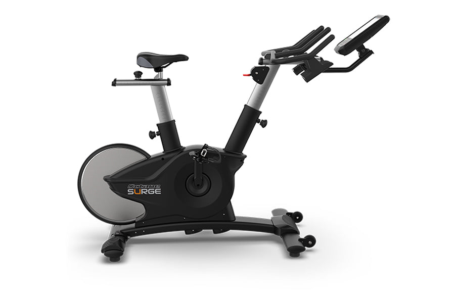 TRUE Surge indoor cycle with black frame, gray accents, upright seat, and dual handlebars on white background