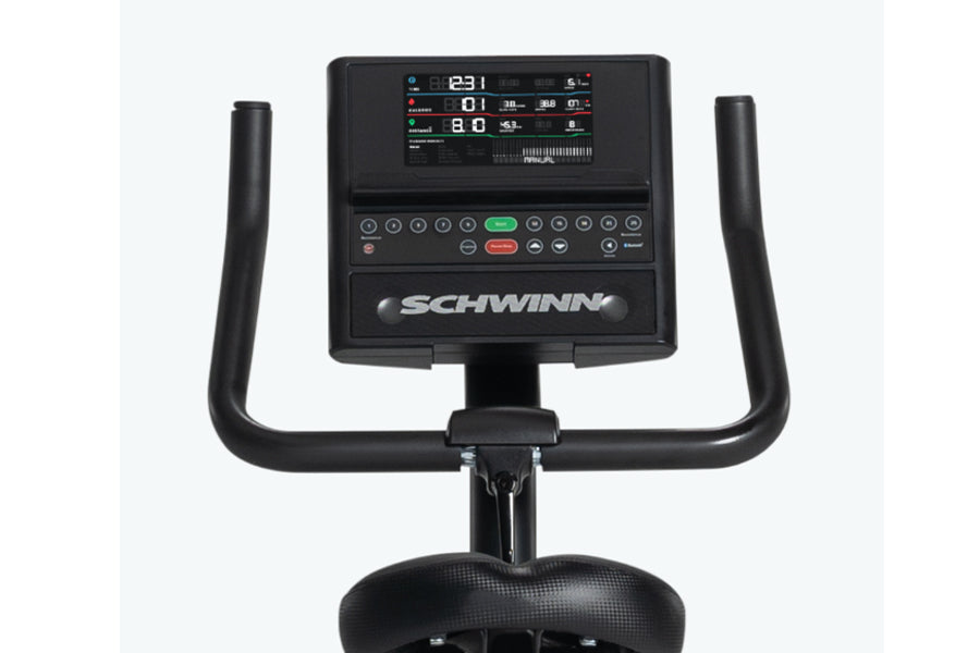 Schwinn 190 upright exercise bike with digital console displaying workout metrics, black frame, dual handles, and textured se