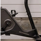 Schwinn 190 upright exercise bike with black frame, flywheel, and vertical handlebars against brick wall