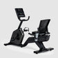 Black Schwinn 290 recumbent exercise bike with digital console, mesh backrest, and water bottle holder on white background