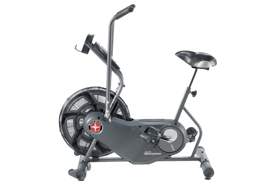 Schwinn Airdyne AD6 stationary exercise bike with gray frame, large black fan wheel, handlebars, and adjustable seat on white
