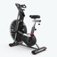 Schwinn Airdyne AD7 stationary exercise bike with black frame, dual-handle grips, padded seat, and large air fan wheel on whi