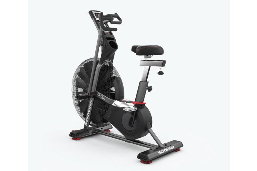Schwinn Airdyne AD7 stationary exercise bike with black frame, dual-handle grips, padded seat, and large air fan wheel on whi