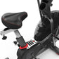 Schwinn Airdyne AD7 stationary exercise bike with black frame, padded seat with red trim, and large front fan wheel on white 