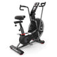 Black Schwinn Airdyne AD7 stationary exercise bike with dual handles, padded seat, digital display console, and air resistanc