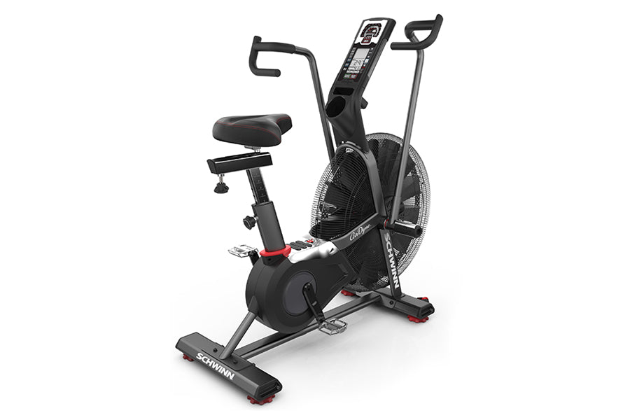 Black Schwinn Airdyne AD7 stationary exercise bike with dual handles, padded seat, digital display console, and air resistanc