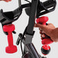 Schwinn IC4 indoor cycling bike with black frame, red handlebar grips, and red dumbbell weights held by model's hands